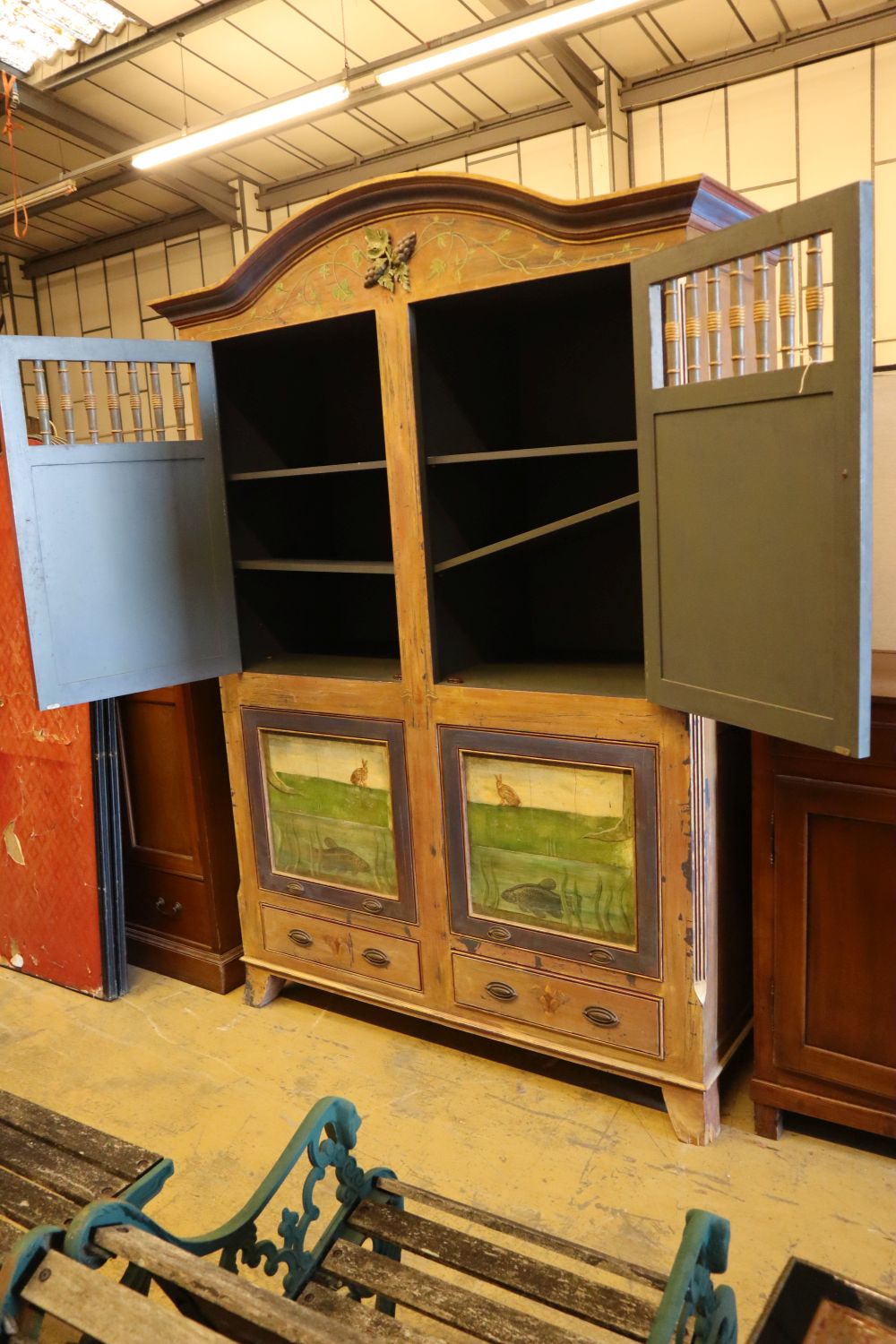 A 19th century Continental painted armoire, later decorated with birds on branches, rabbits and fish, the top two doors each enclosing